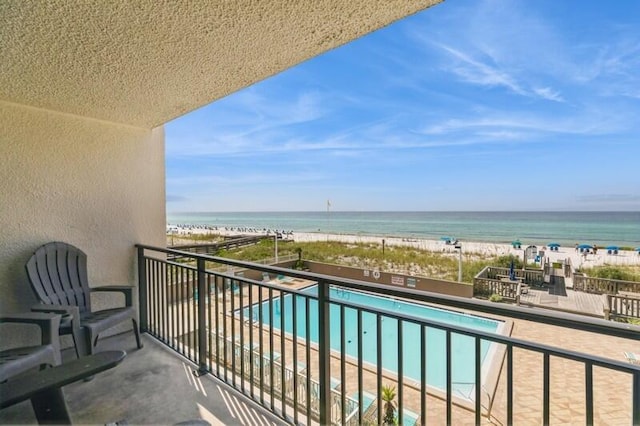 balcony with a water view and a beach view