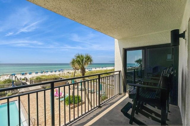 balcony with a view of the beach and a water view