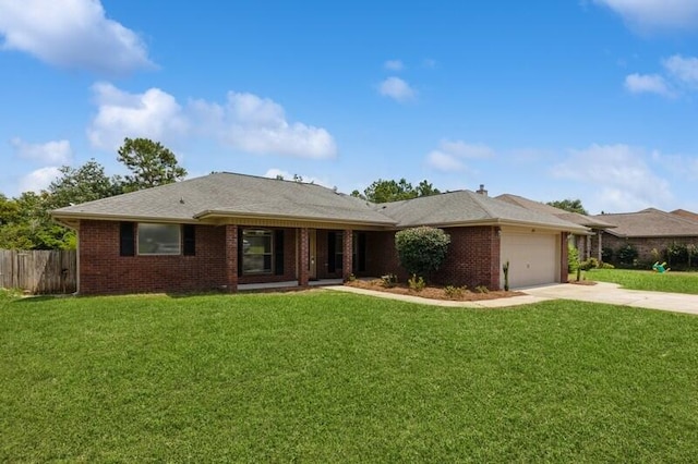 single story home with brick siding, fence, concrete driveway, and a front yard