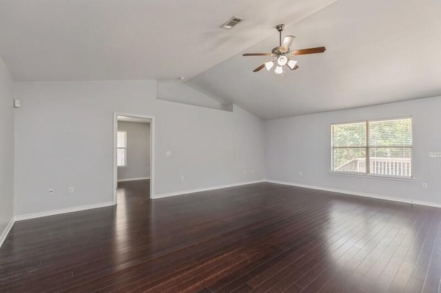 unfurnished room with a healthy amount of sunlight, dark hardwood / wood-style flooring, ceiling fan, and lofted ceiling