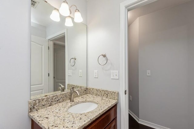 bathroom with vanity and a chandelier