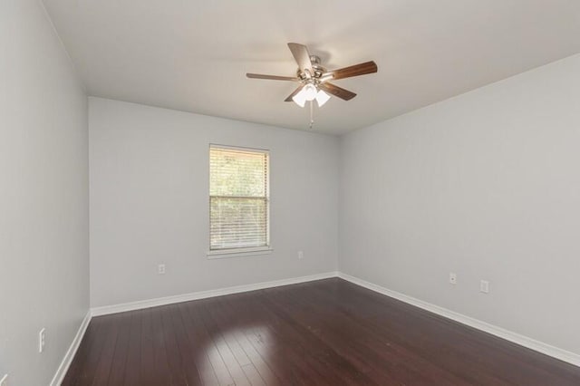 unfurnished room with dark wood finished floors, baseboards, and ceiling fan