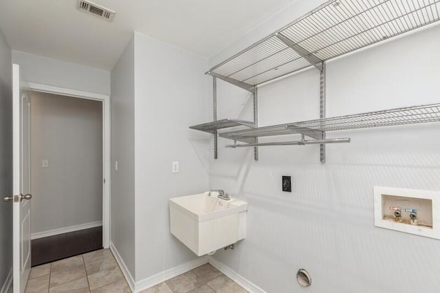 washroom with hookup for a washing machine, visible vents, electric dryer hookup, laundry area, and baseboards