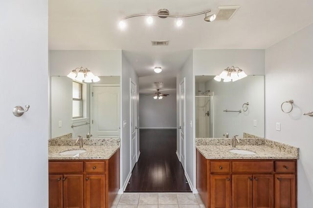 bathroom featuring ceiling fan, wood-type flooring, walk in shower, and vanity