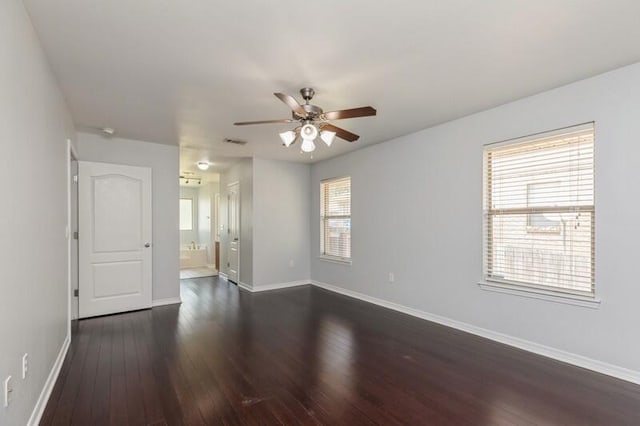 spare room featuring ceiling fan and dark hardwood / wood-style flooring