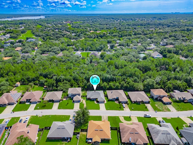 drone / aerial view featuring a forest view and a residential view