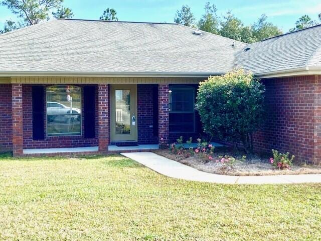 ranch-style house with a front lawn