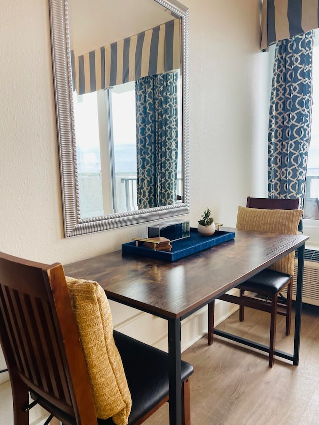 dining space featuring a healthy amount of sunlight and hardwood / wood-style floors