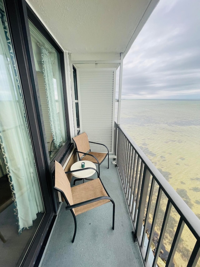 balcony featuring a water view