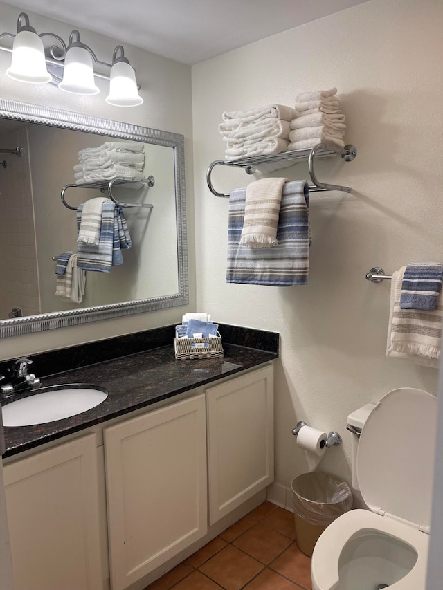 bathroom featuring tile patterned floors, toilet, and vanity