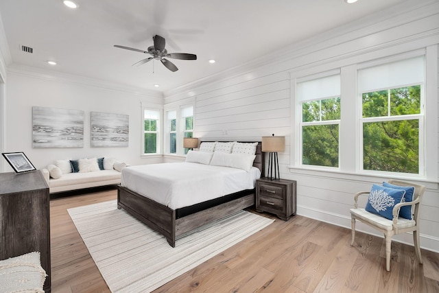 bedroom featuring ceiling fan, light hardwood / wood-style flooring, and crown molding