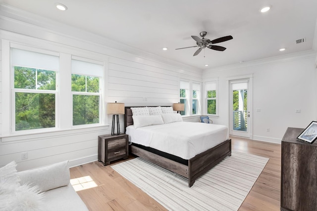 bedroom featuring access to exterior, light wood-type flooring, baseboards, and ornamental molding