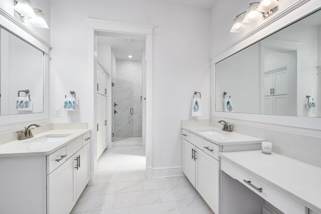 full bathroom with two vanities, marble finish floor, a marble finish shower, and a sink