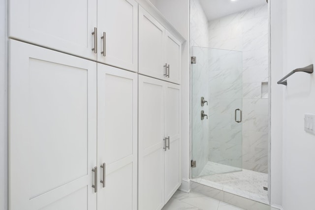 bathroom with marble finish floor and a marble finish shower