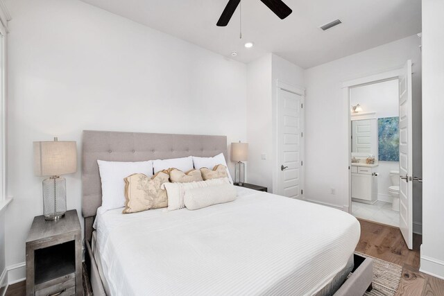 bedroom featuring ceiling fan, connected bathroom, and light hardwood / wood-style floors