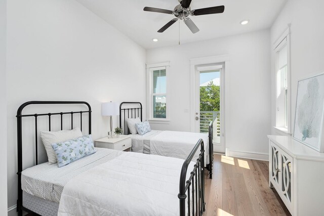 bedroom featuring ceiling fan, light hardwood / wood-style floors, and access to outside