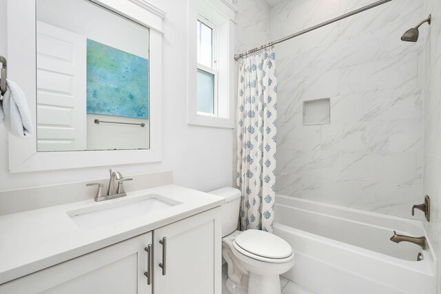 full bathroom with tile patterned flooring, shower / bath combination with curtain, vanity, and toilet