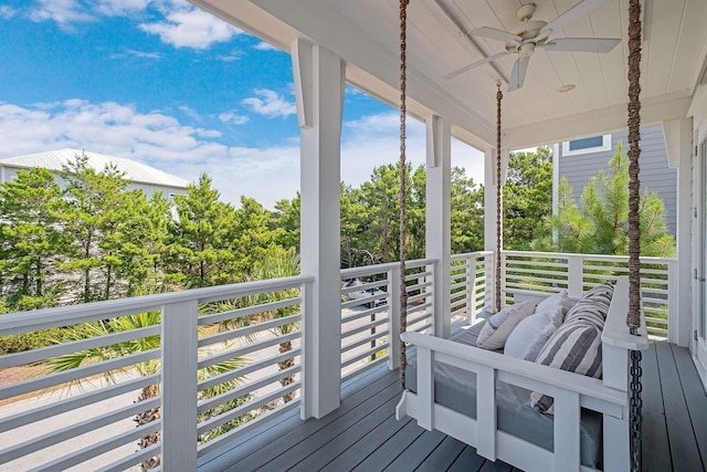 wooden terrace featuring ceiling fan