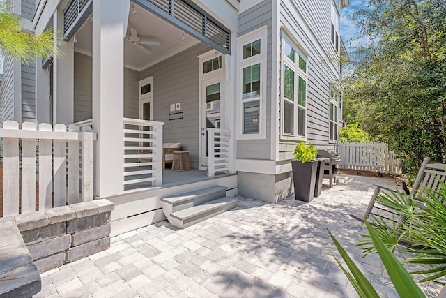 view of patio / terrace with a ceiling fan and fence