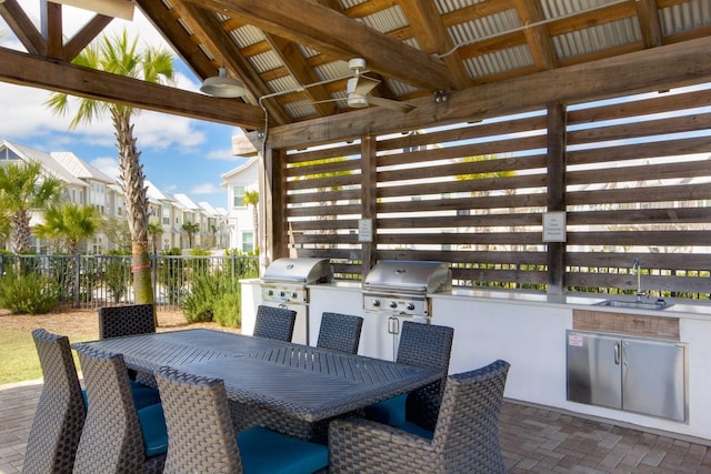 view of patio / terrace featuring outdoor dining space, a ceiling fan, area for grilling, a sink, and grilling area