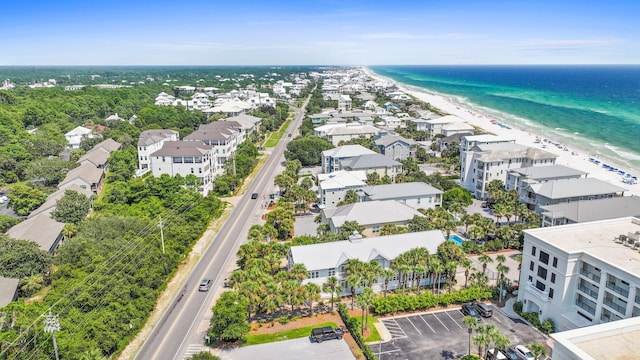 birds eye view of property with a water view and a view of the beach