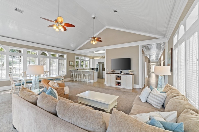 living room with lofted ceiling and crown molding