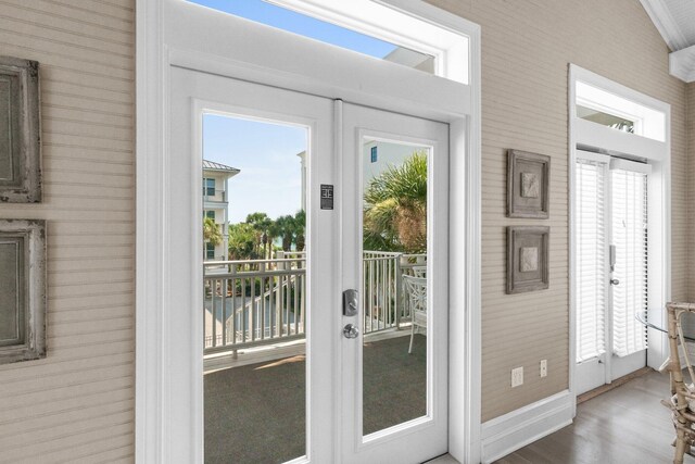 doorway with hardwood / wood-style floors, a wealth of natural light, and french doors