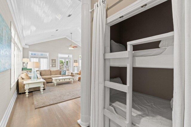 bedroom with vaulted ceiling, light hardwood / wood-style floors, and crown molding