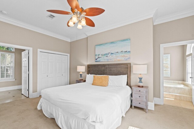 carpeted bedroom with ceiling fan, ensuite bath, a closet, and crown molding