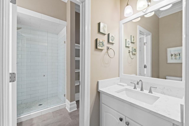 bathroom with crown molding, toilet, a shower with shower door, tile patterned flooring, and vanity