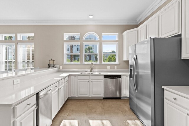 kitchen with crown molding, stainless steel appliances, white cabinets, light tile patterned floors, and sink