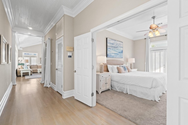 bedroom with ceiling fan, light hardwood / wood-style floors, and crown molding