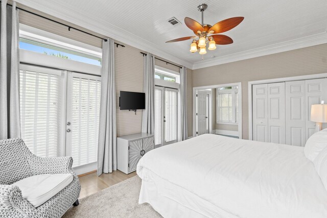 bedroom with ceiling fan, crown molding, and light wood-type flooring