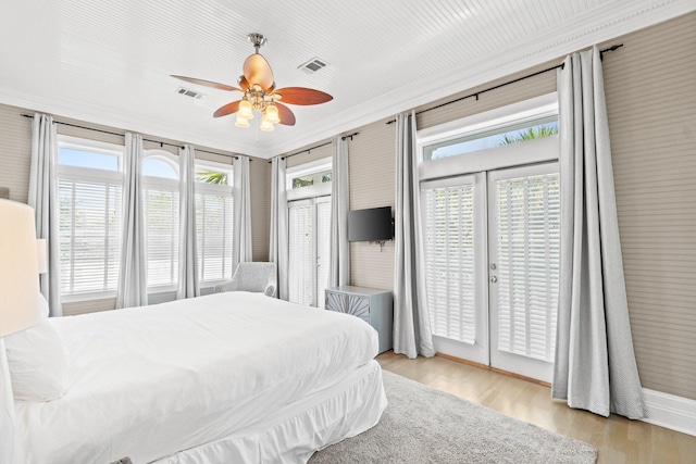 bedroom featuring ceiling fan, access to exterior, light wood-type flooring, and french doors