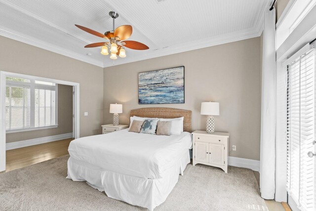 bedroom featuring ceiling fan, ornamental molding, and light hardwood / wood-style floors