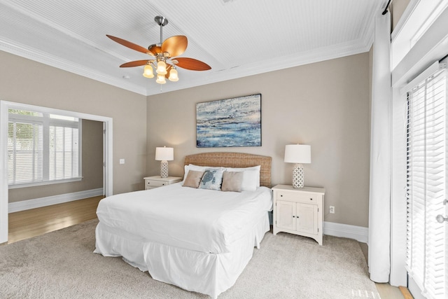 bedroom featuring ceiling fan, ornamental molding, and light hardwood / wood-style flooring