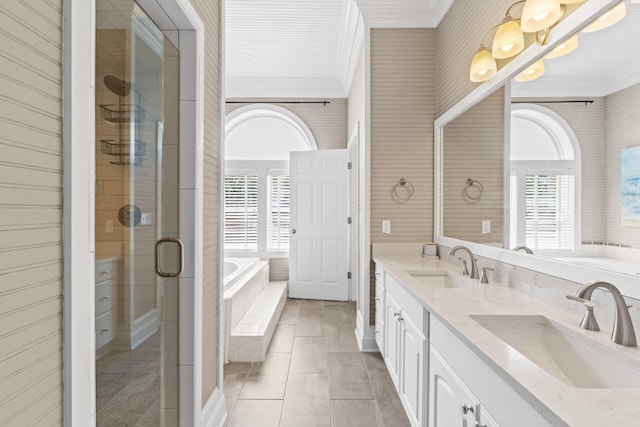 bathroom with ornamental molding, separate shower and tub, and a healthy amount of sunlight