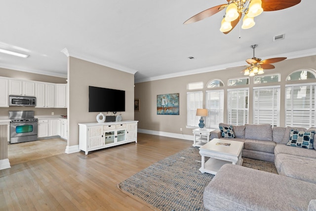 living room with ornamental molding and light hardwood / wood-style floors