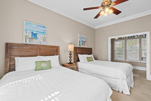 bedroom with light colored carpet, crown molding, and ceiling fan