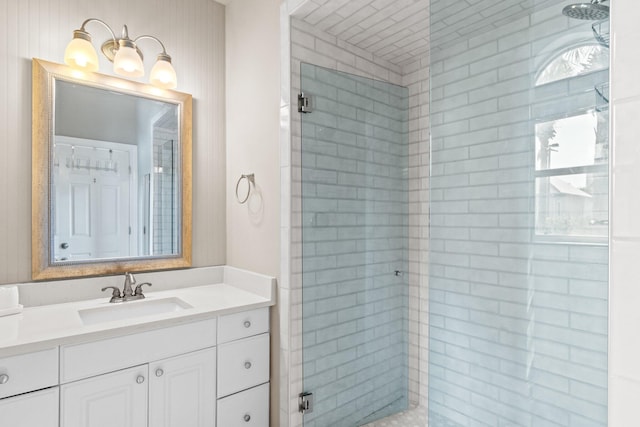 bathroom with walk in shower and vanity