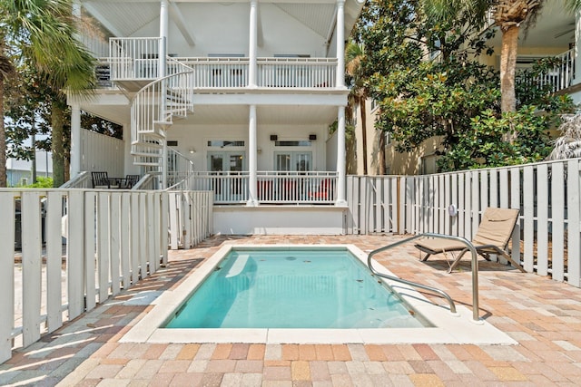 view of pool with a patio and french doors