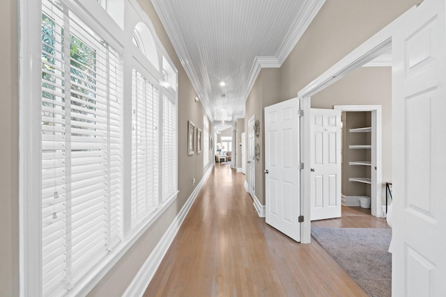 hall featuring crown molding and light hardwood / wood-style flooring