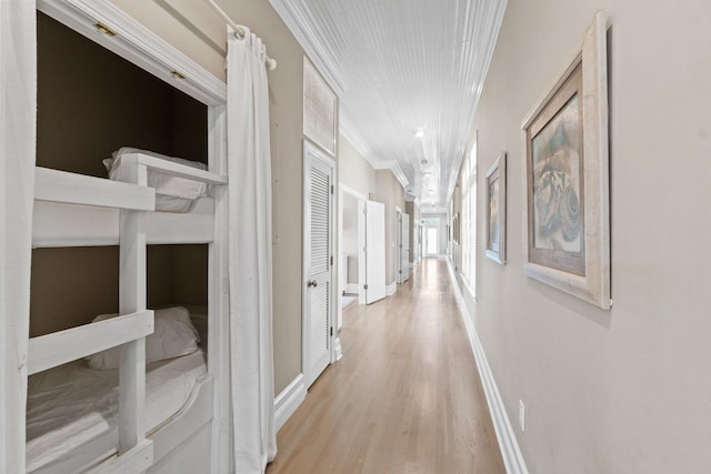 hall with crown molding and light hardwood / wood-style flooring