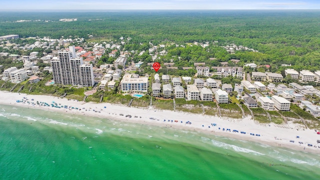 birds eye view of property with a water view and a beach view