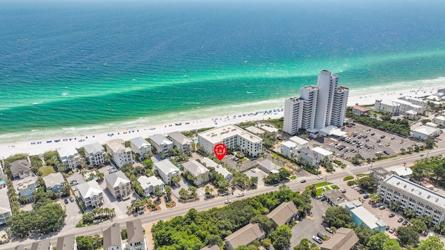 drone / aerial view with a water view and a beach view