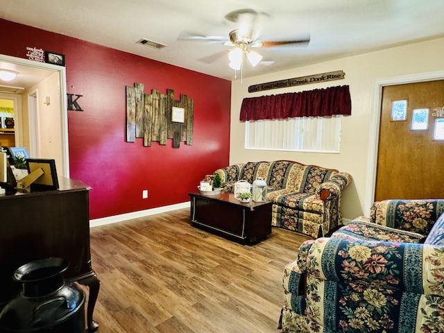 living room featuring ceiling fan and hardwood / wood-style flooring