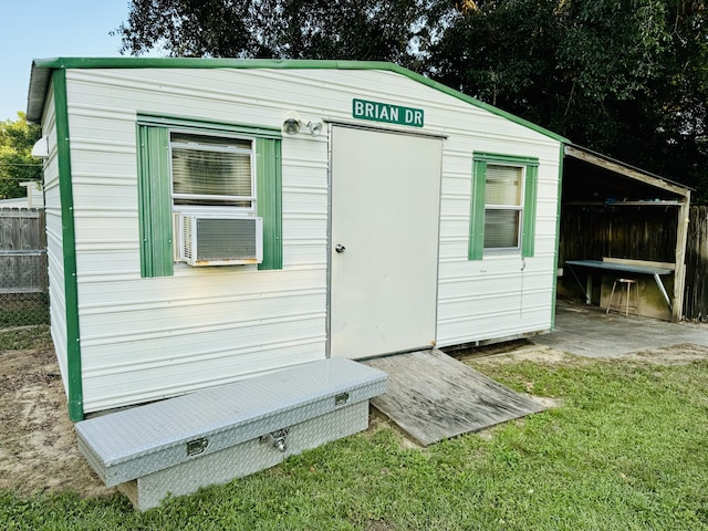 view of outdoor structure with cooling unit and a lawn