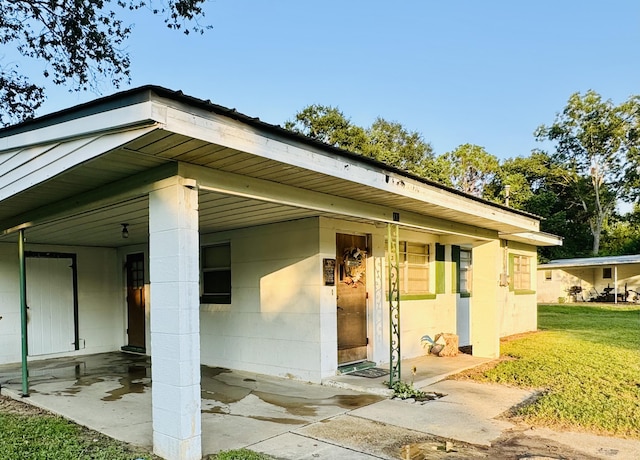 back of property featuring a lawn