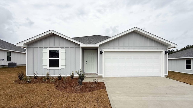 ranch-style house with central AC unit and a garage