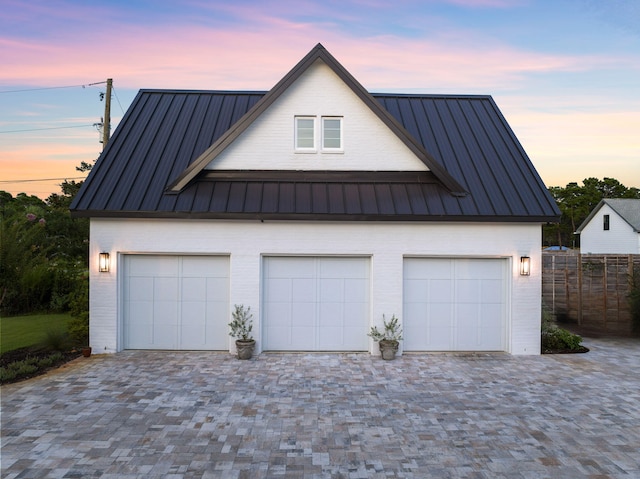 view of garage at dusk